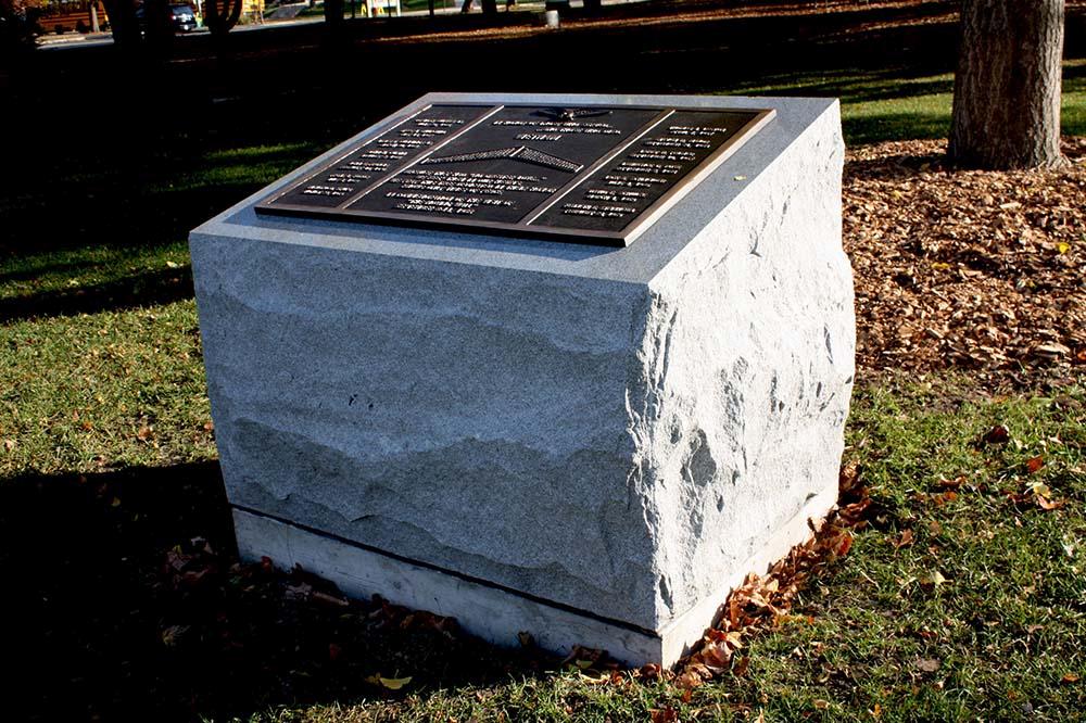 Bronze plaque on granite in slab of white stone