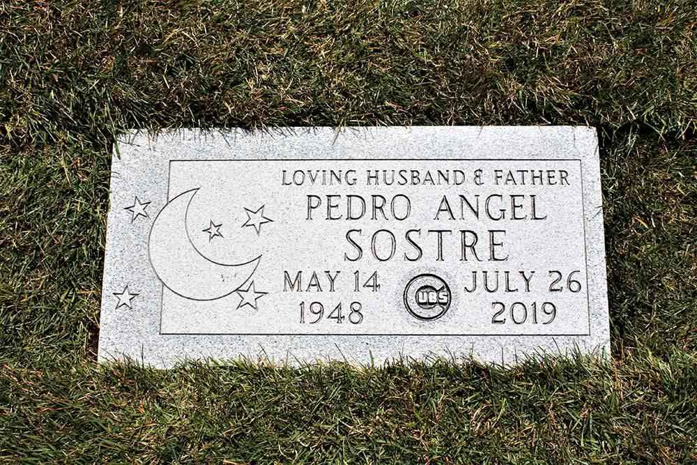 Grey granite marker with moon, stars, and Cubs logo