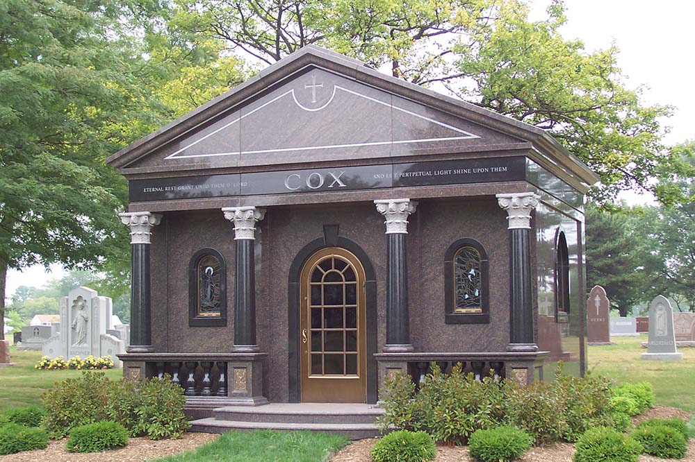 Private mausoleum with ornate columns, multiple stained glass windows