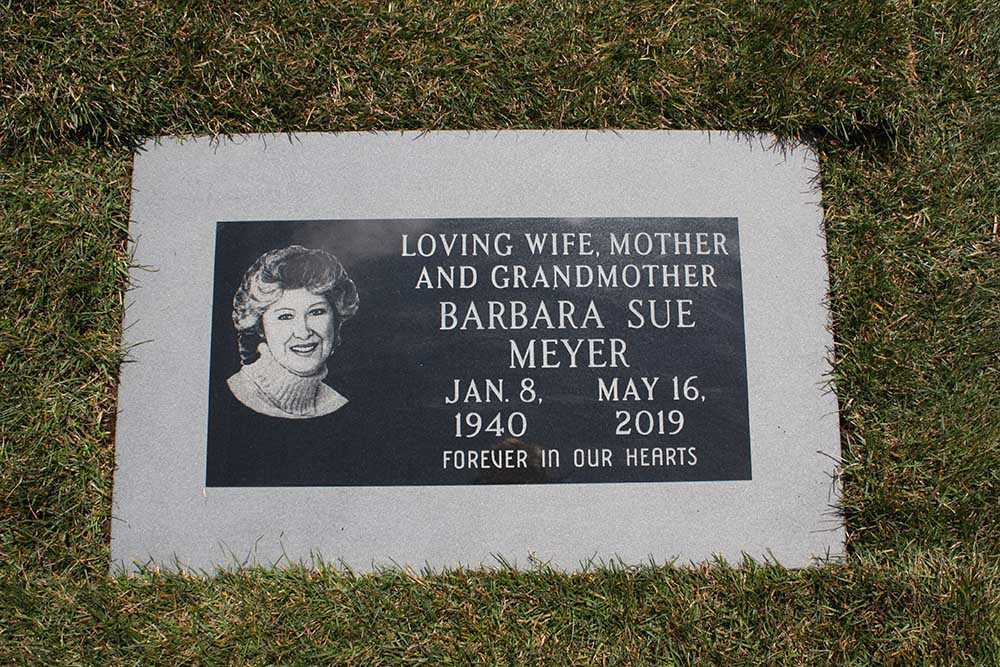 Black granite marker with hand engraved portrait and integrated granite foundation