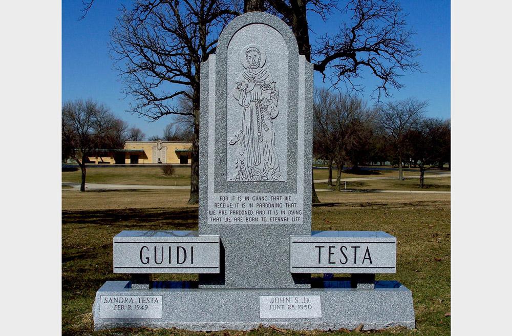 Family monument with St. Francis carving & 2 family names