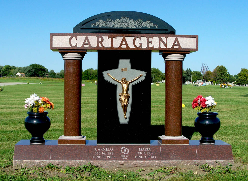 Large family monument with columns and a bronze depiction of Jesus