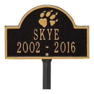 Small black and gold plaque finish with image of dog paw and dates