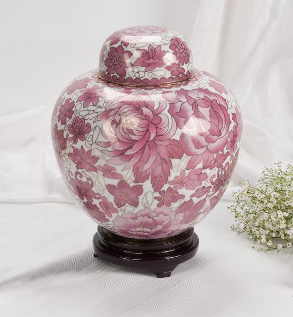 Round flower shaped pink and white urn with lid